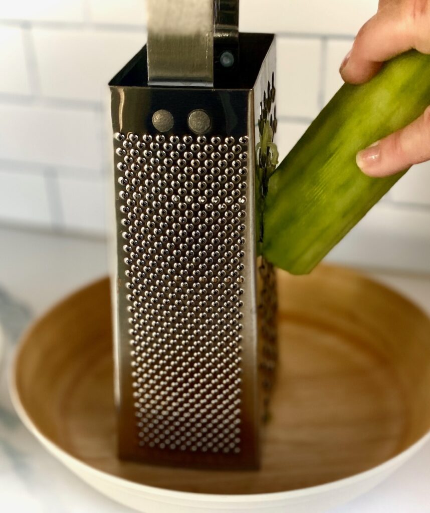 Shredding cucumbers on box grater