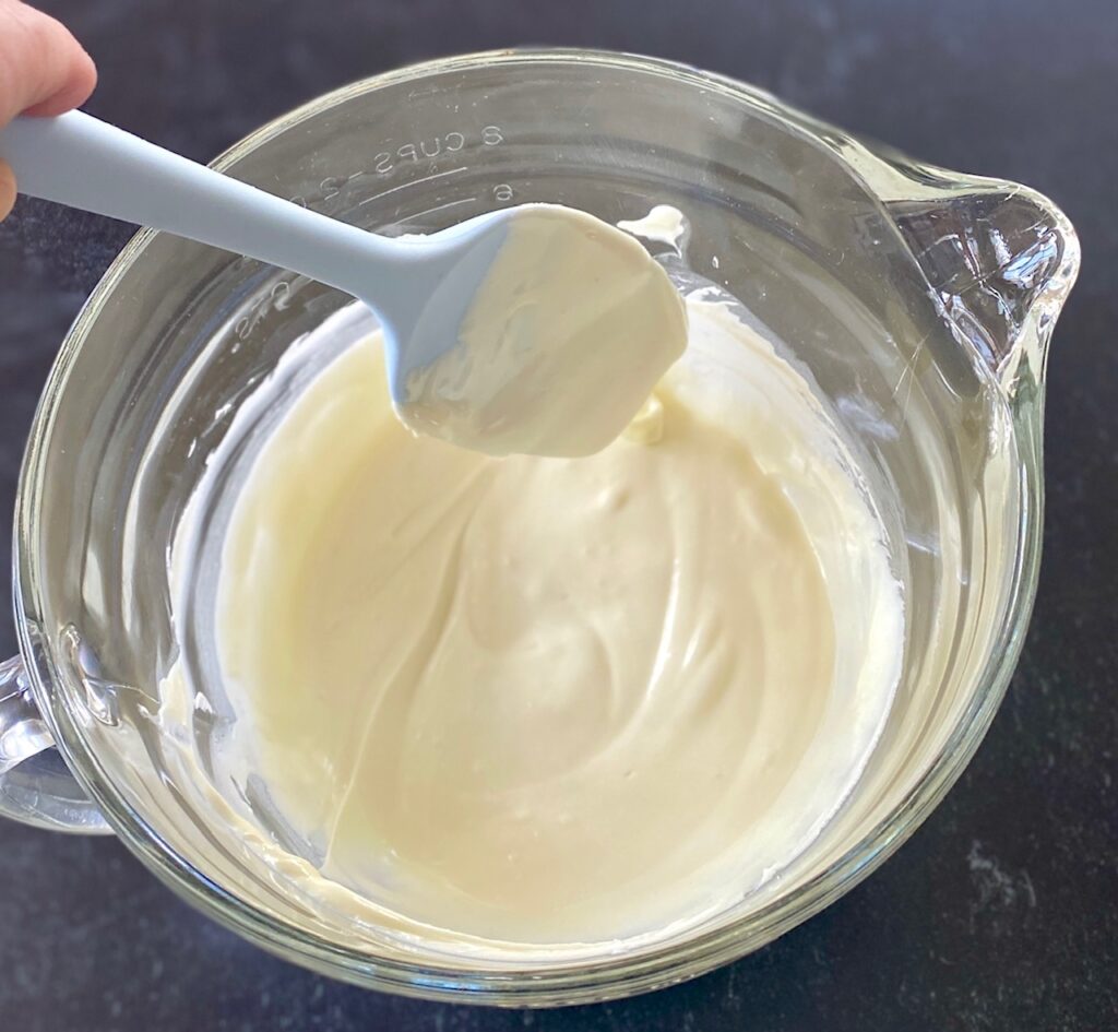 melted white chocolate in glass bowl