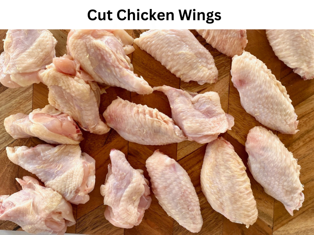 cut chicken wings on wood board