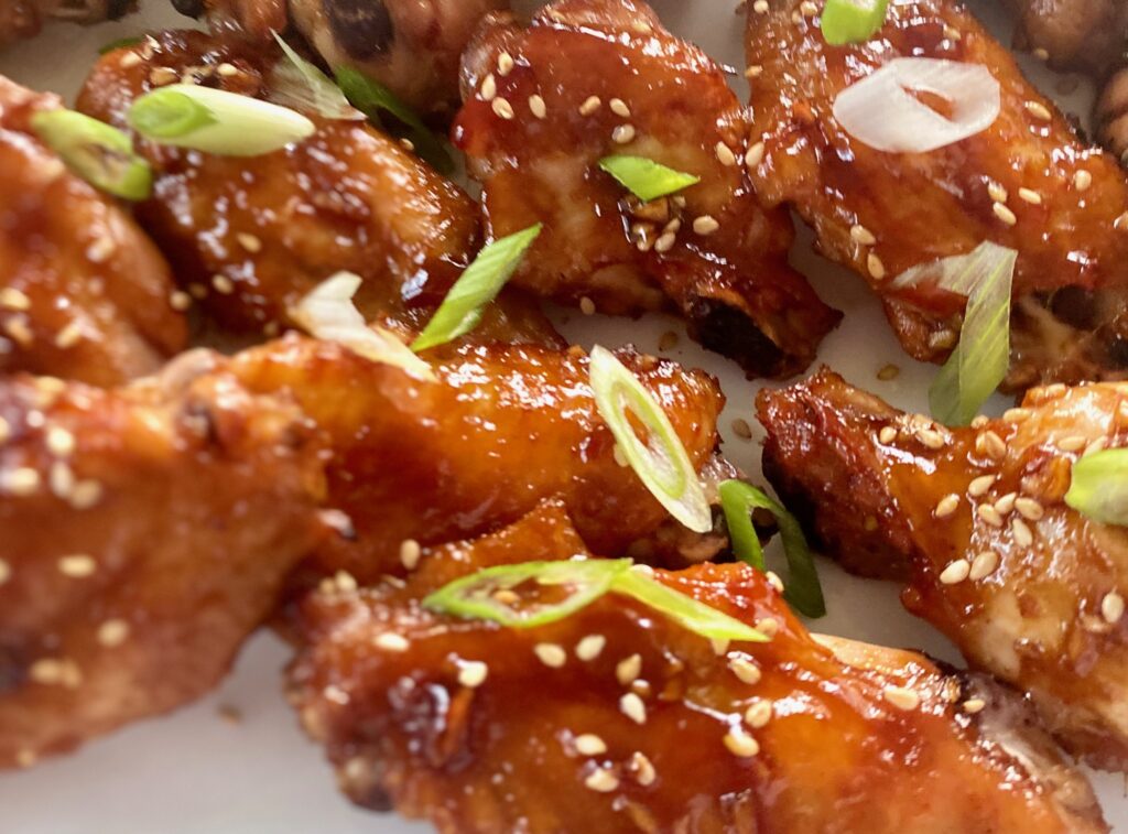 wings with an asian coating and scallions