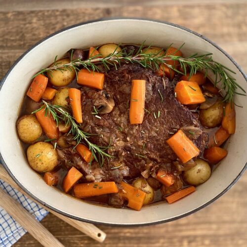 Pan of pot roast with spoons