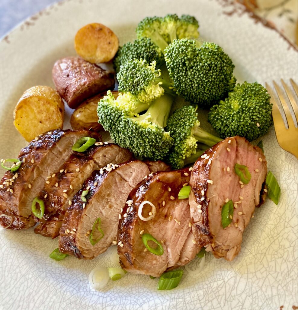 pork, potatoes and broccoli on white plate