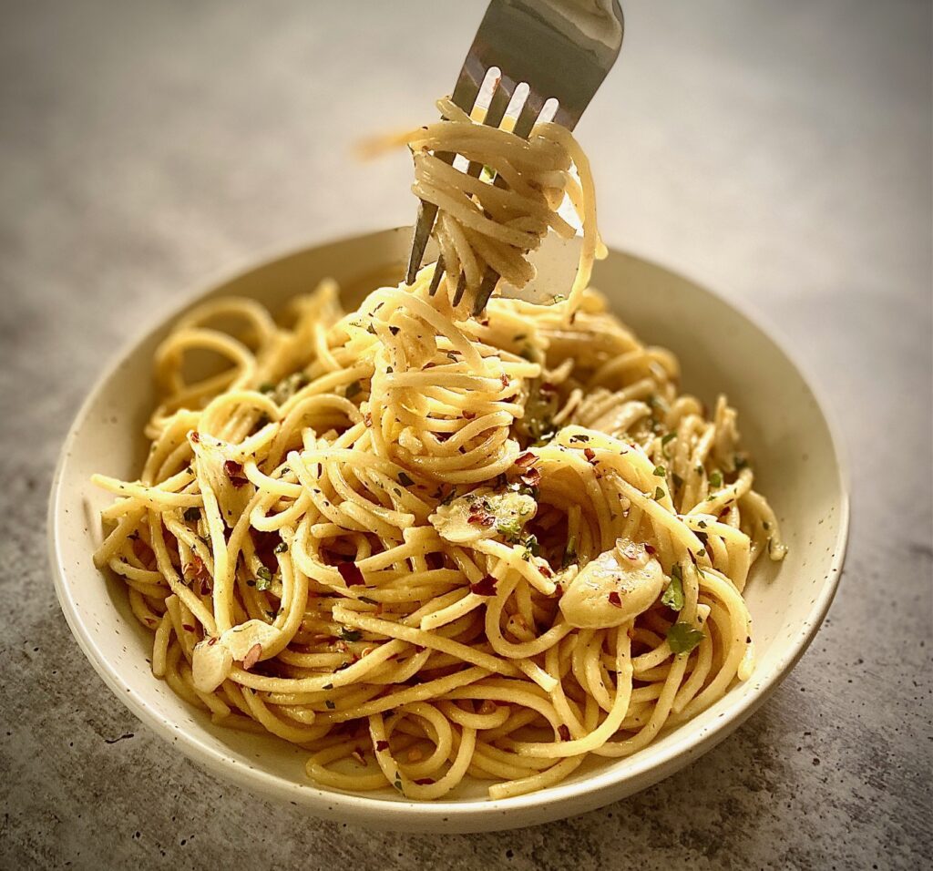 bowl of pasta twisted on a fork