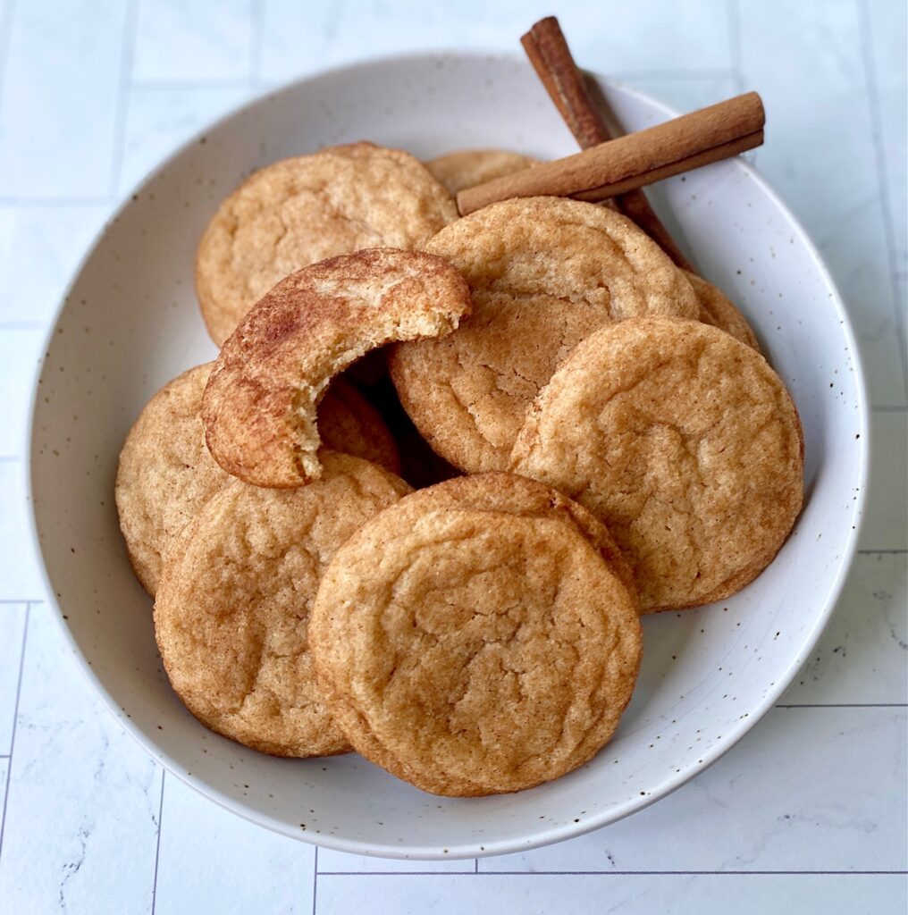 bowl of snickerdoodle cookies with cinnamon sticks
