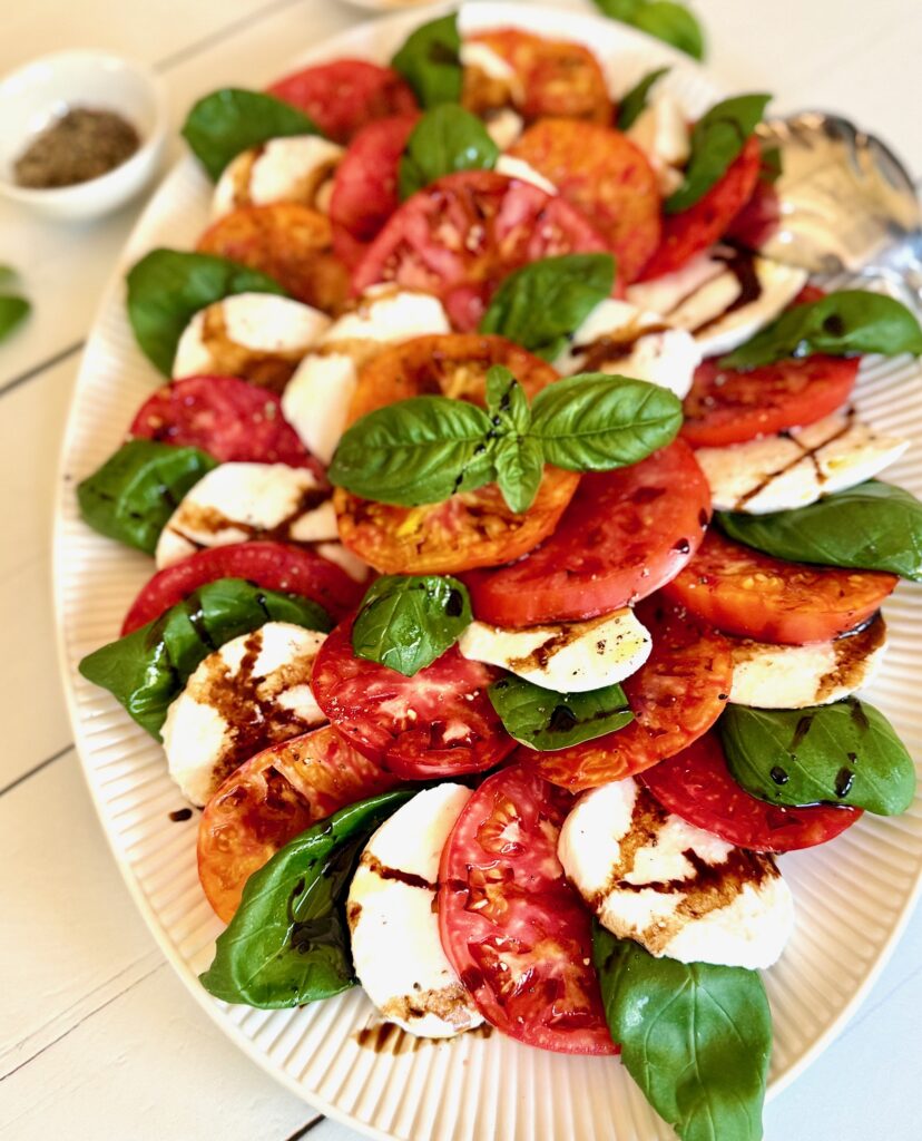 Caprese salad on white platter