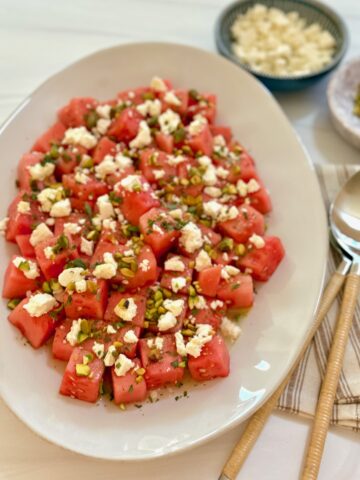 a platter of watermelon feta salad with spoon