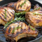 4 pork chops in a black pan
