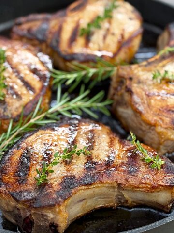 4 pork chops in a black pan