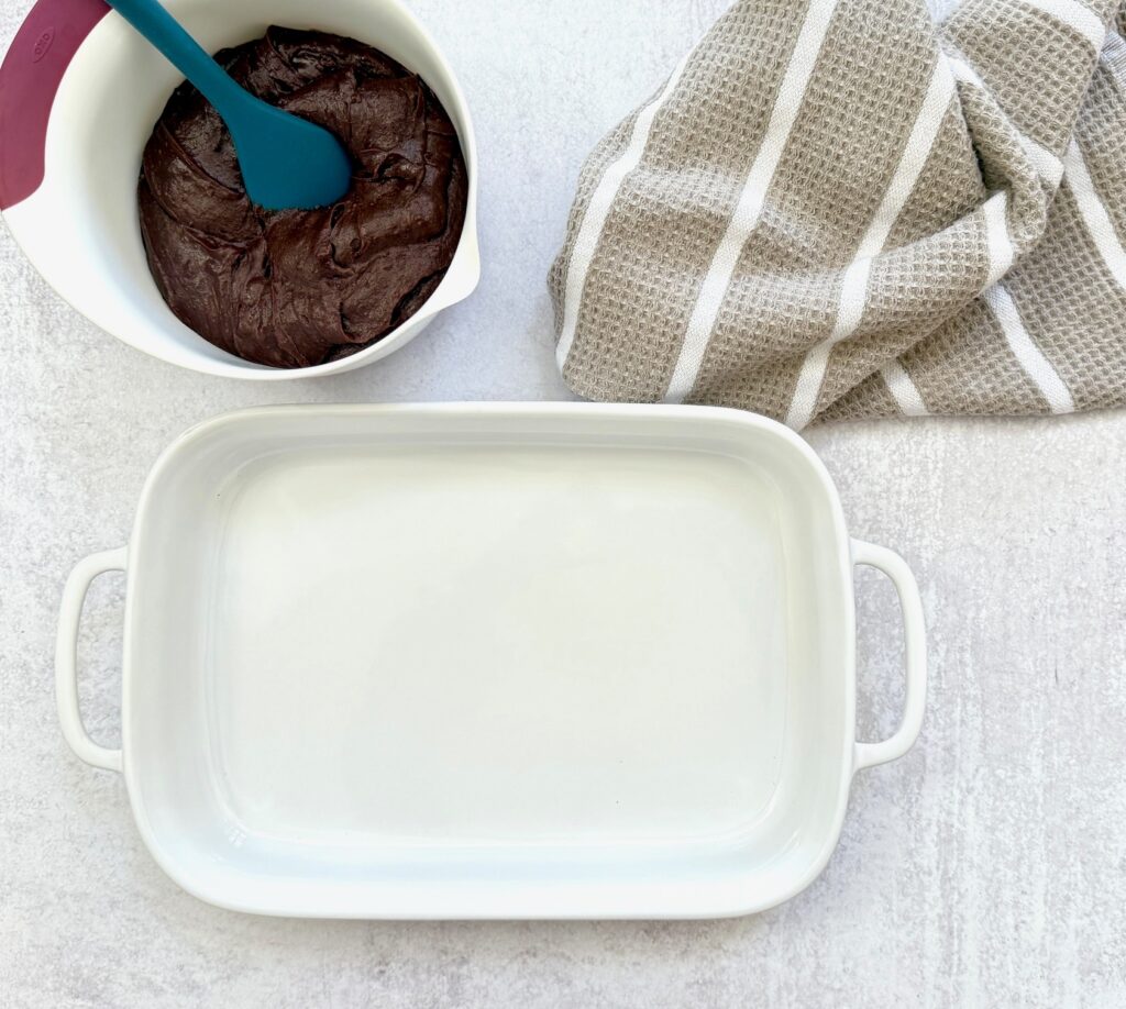 white pan and brownie mix with spoon