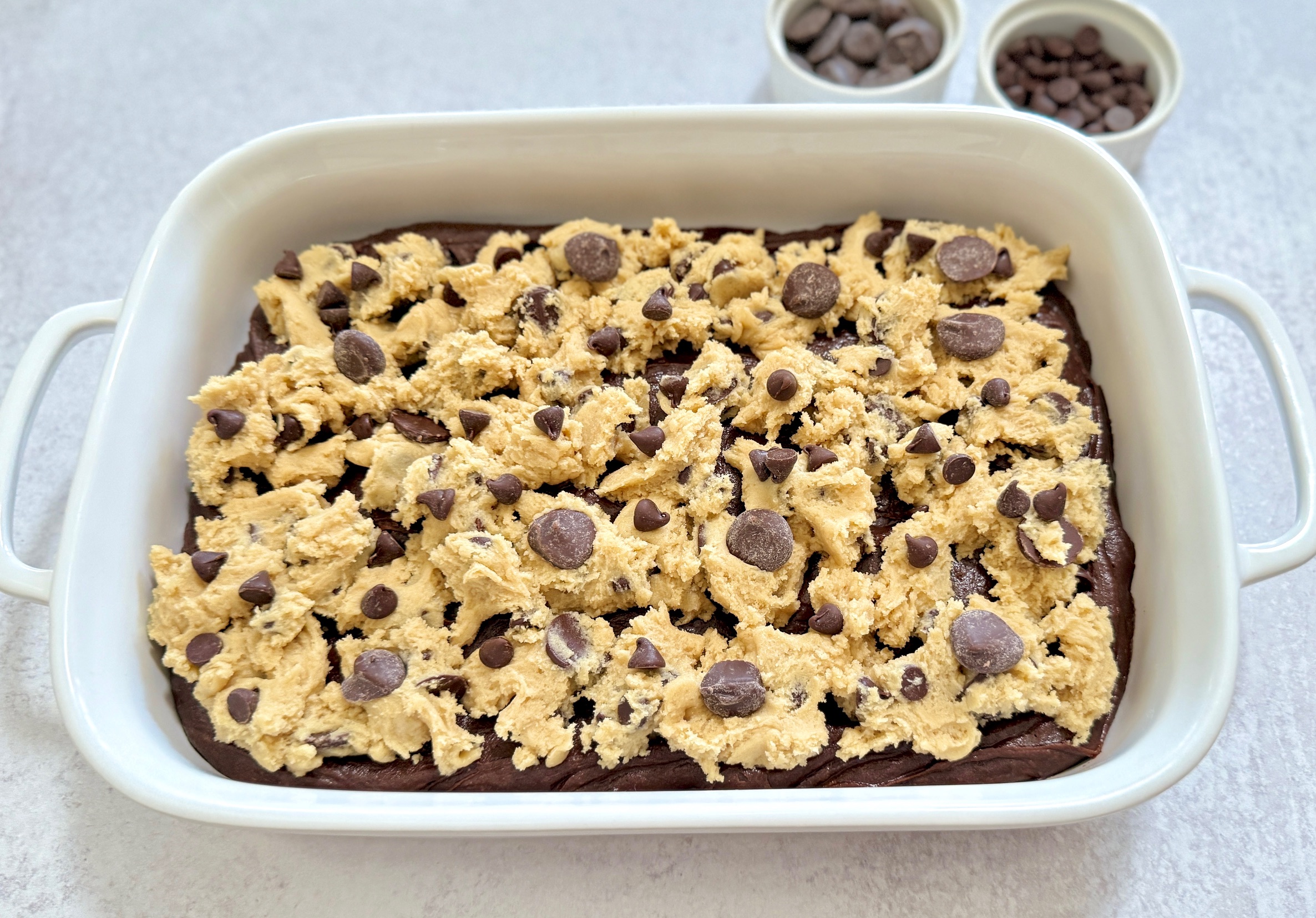 white pan of cookie dough and brownies