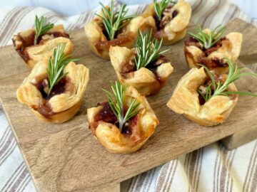 wooden board with brie puff bites