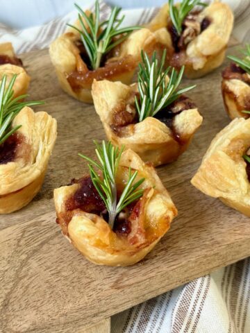 wooden board with brie puff bites