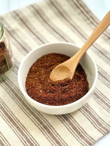 Chili seasoning with jar and bowl and spoon
