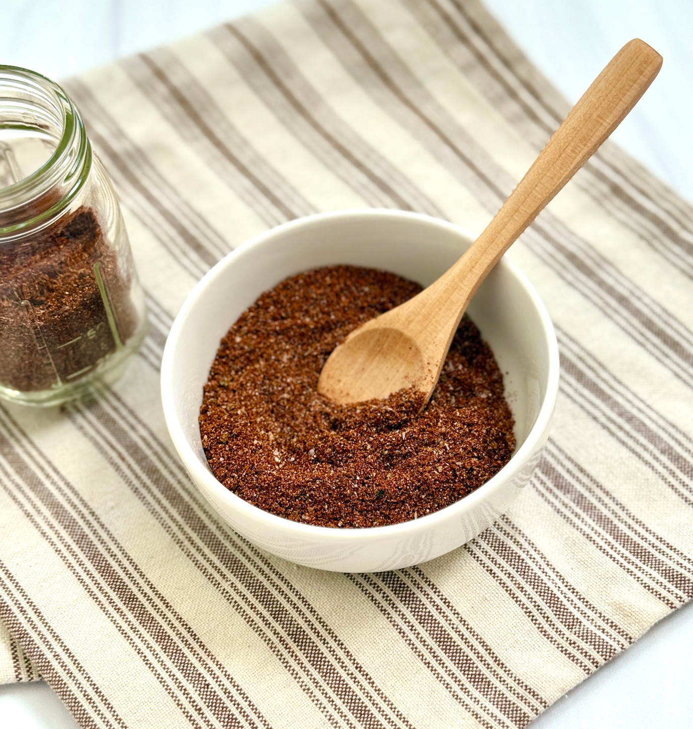 Chili seasoning with jar and bowl and spoon