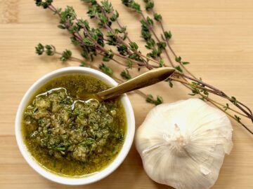 beef rub seasoning, bulb of garlic, and sprigs of fresh thyme