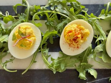 Four deviled eggs on platter