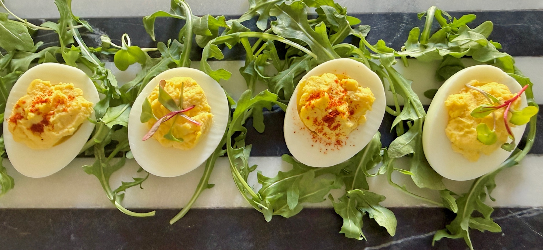 Four deviled eggs on platter