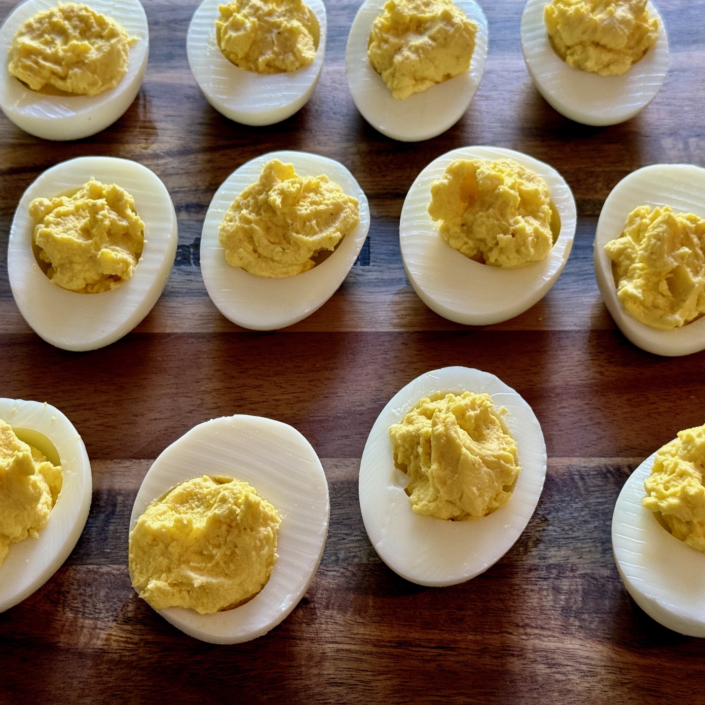 eggs with filling on a wood cutting board