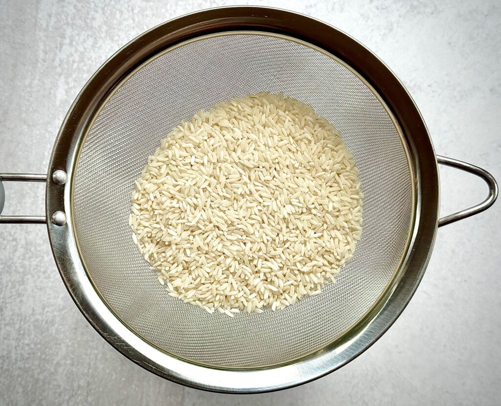 white rice in a colander
