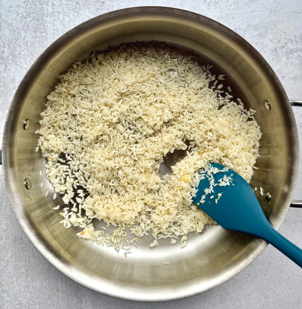 rice and garlic toasting a pan
