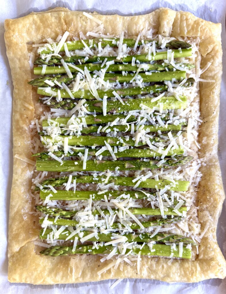 Parmesan cheese on top of asparagus pie